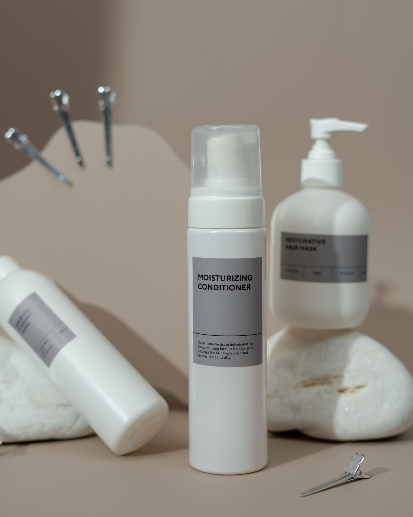 A labelled conditioner bottle beside hair accessories