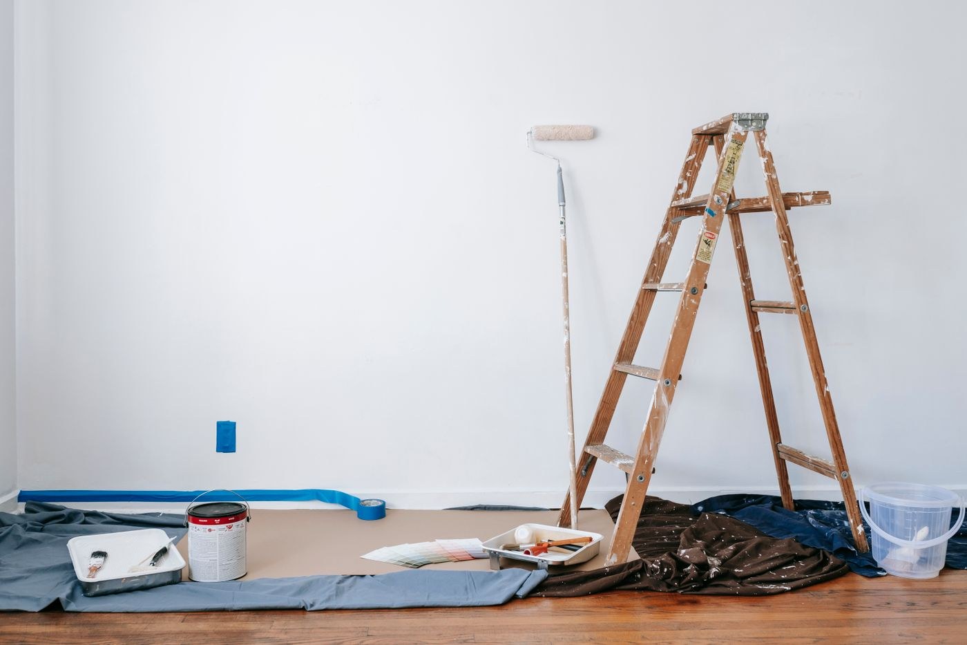 A room prepared for painting with drop cloth and tools