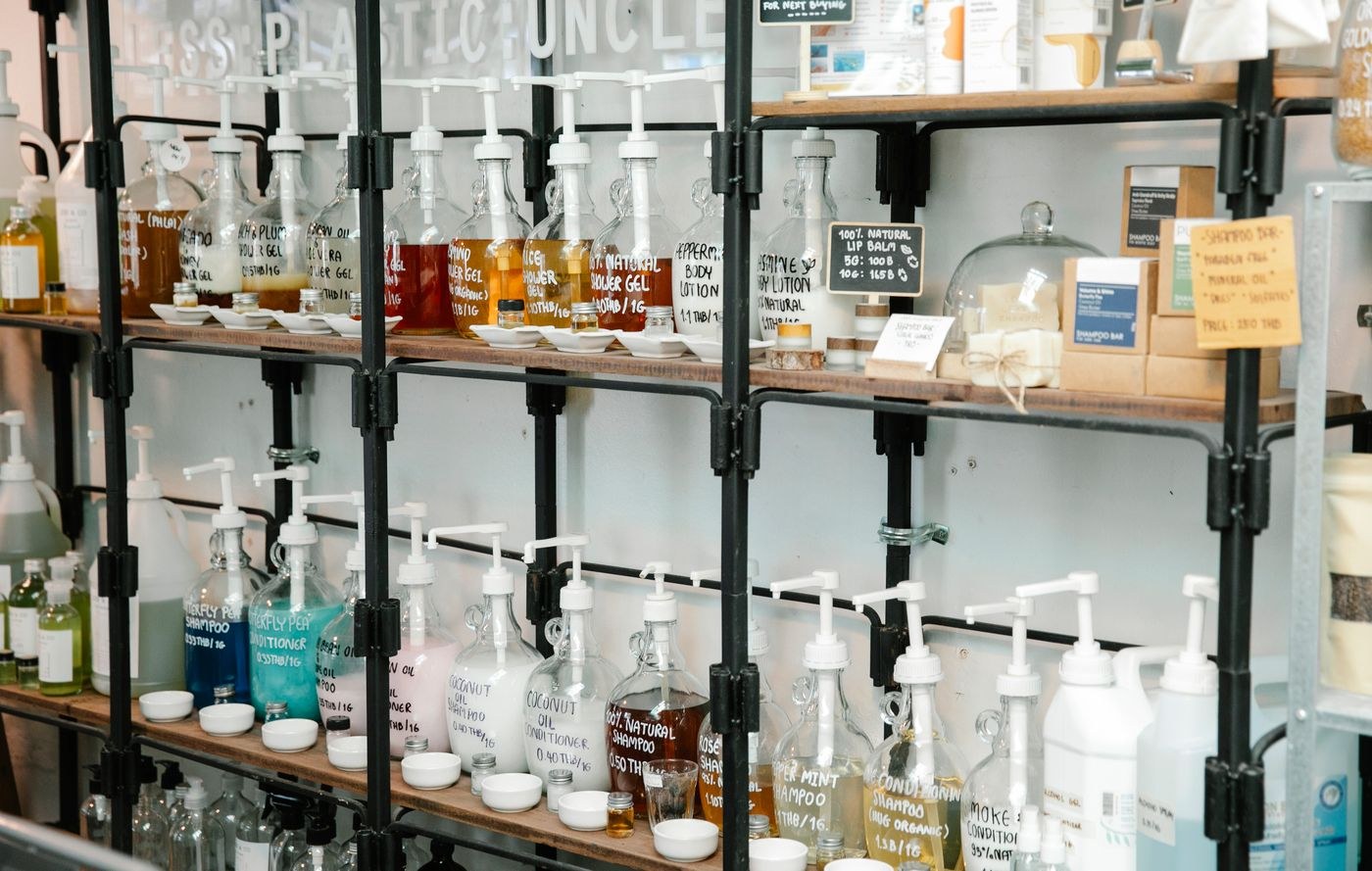Labelled liquid-soap refill bottles on shelves